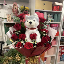 Bouquet of red roses with a plush wolf in the center