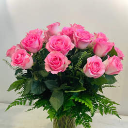 Pink roses arranged in a clear glass vase