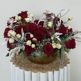 Red and white rose arrangement in a glass vase