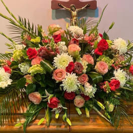 Large floral arrangement with red and blush roses and white blooms