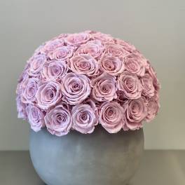 Round bouquet of pale pink roses in a gray vase