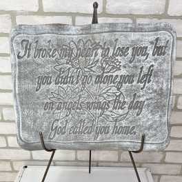 Decorative plaque on a metal stand with a floral quote