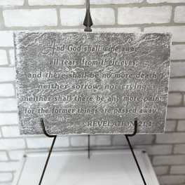 Decorative sign with a Bible verse on a metal stand
