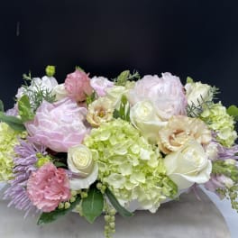 Pastel floral arrangement with roses, hydrangeas, and carnations