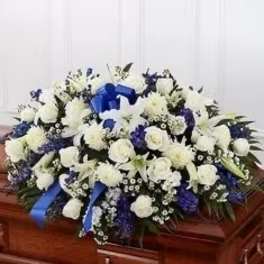 White and blue funeral spray on a casket