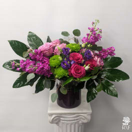 Bouquet of pink and purple flowers in a dark vase