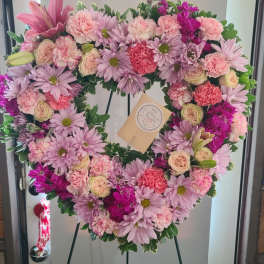 Heart-shaped floral wreath with pink and lavender flowers