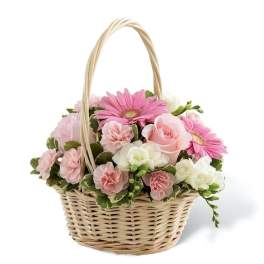 Pink and white flowers arranged in a wicker basket