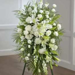 Tall white floral standing spray with lilies and roses