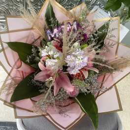 Pink and white mixed bouquet wrapped in blush paper
