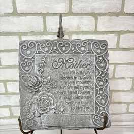 Gray memorial plaque with roses on a metal stand