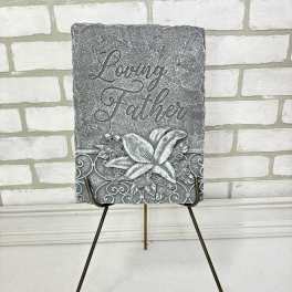 Gray memorial plaque on a metal easel with the words Loving Father