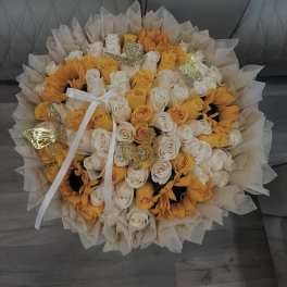 Bouquet of white and yellow roses with sunflowers and butterfly accents