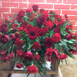 Large red floral arrangement with roses and carnations