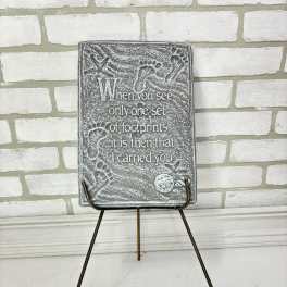 Decorative memorial plaque on a metal easel with a footprint design