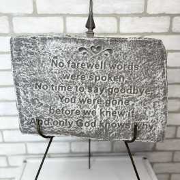 Memorial plaque with a sympathy quote on a metal stand