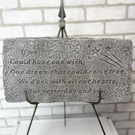 Stone plaque on a metal easel with an engraved quote and stars