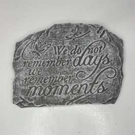 Decorative stone plaque with the words "We do not remember days, we remember moments"