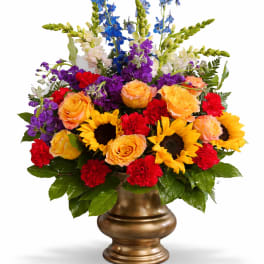 Colorful mixed flower arrangement in a gold vase
