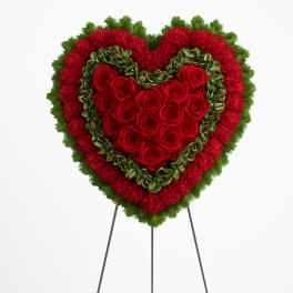 Heart-shaped floral standing spray with red roses and red and green carnations
