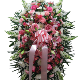 Tall standing spray with pink and white flowers and a large pink ribbon bow