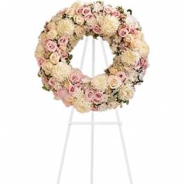 Pastel floral wreath on a white stand