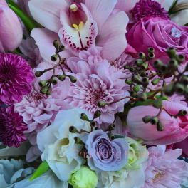 Pink orchid and mixed pink flowers in a close-up bouquet