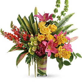 Colorful bouquet of lilies, roses, and orchids in a glass vase