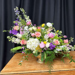 Large mixed bouquet in a gold vase with pink, white, and purple flowers