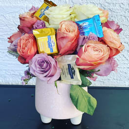 Pink and peach roses with Ghirardelli chocolates in a pink vase