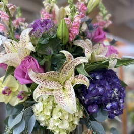Bouquet of lilies, roses, hydrangea, and snapdragons in pink, purple, and white