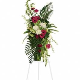 Tall floral spray with pink and white blooms on a white easel
