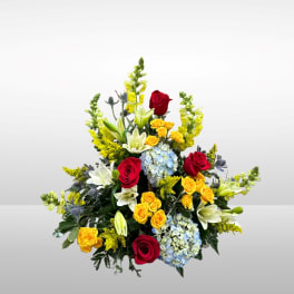 Mixed bouquet with red and yellow roses, lilies, and blue hydrangeas