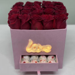Pink box of red roses with a drawer of chocolates