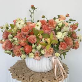 Peach and cream bouquet in a white ribbed vase