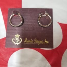 Pair of gold hoop earrings on a branded display card
