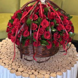 Basket of red roses with ribbon streamers