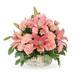 Pink lilies and carnations in a white basket