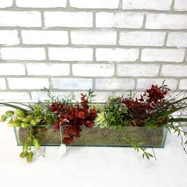 Long rectangular planter with red and green succulents and trailing foliage