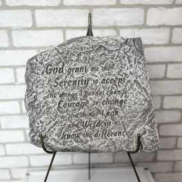 Decorative stone plaque with an engraved Serenity Prayer on a metal stand