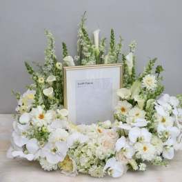 White floral frame arrangement with orchids and calla lilies