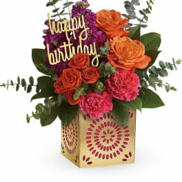 Birthday flower arrangement in a gold box with roses and carnations