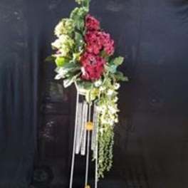 Tall floral standing arrangement with pink and white flowers on a metal stand