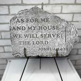 Engraved memorial stone on a metal stand with a Bible verse and cross