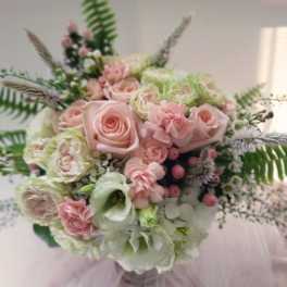 Pastel bouquet of roses, carnations, and lisianthus with airy greenery