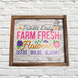 Framed sign reading "Picked Daily Farm Fresh Flowers" with flower graphics