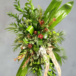 Large green floral spray with red accents and a deer-print ribbon