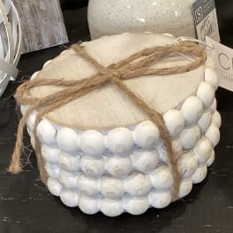 White beaded decorative container tied with twine