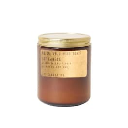 Amber jar candle with a gold lid and label