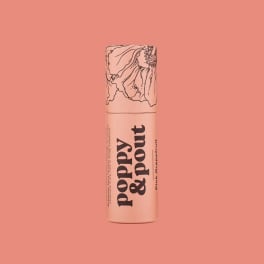 Pink lip balm tube with floral line art on a coral background